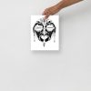 African mask art print featuring an oval face with sacred earrings symbolizing feminine strength