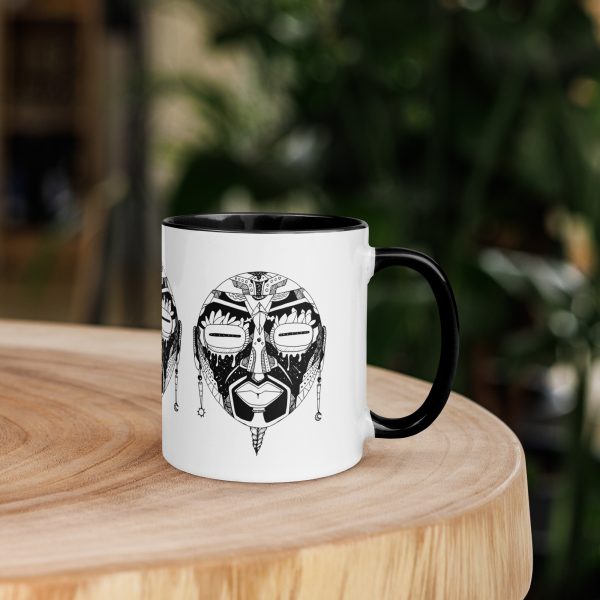 Afrocentric ceramic coffee mug with African mask art, colorful rim, handle, and interior