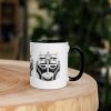 Afrocentric coffee mug featuring colorful African mask art with a vibrant rim, handle, and inside