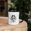 Ceramic afrocentric coffee mug with colorful African mask art design, rim, and handle