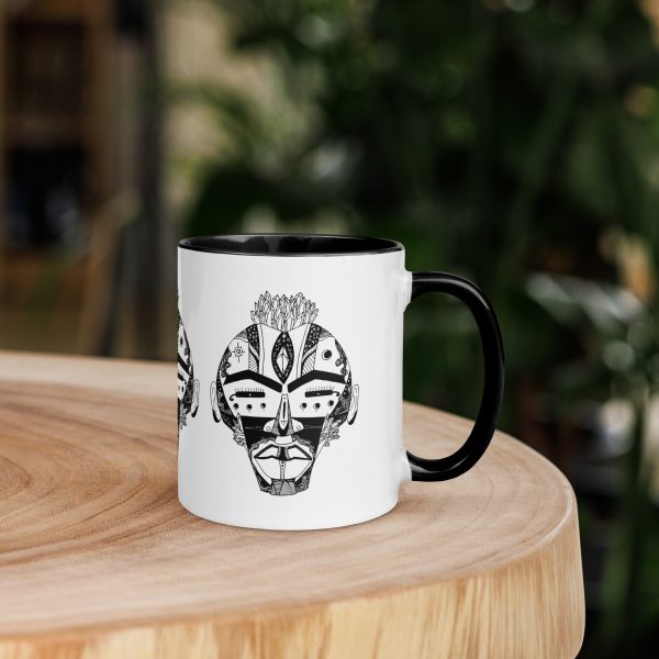Afrocentric coffee mug featuring colorful African mask art with a vibrant rim, handle, and interior