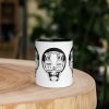 Afrocentric coffee mug with African mask art design and colorful rim, handle, and interior