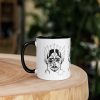 Ceramic Afrocentric coffee mug with African mask art and colorful rim, handle, and interior