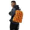 Orange and black African tribal mask backpack with laptop pocket and water-resistant fabric