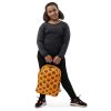 Orange and black African mask tribal backpack with water-resistant material and laptop pocket