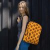 Orange and black African mask print backpack with laptop pocket for school and sports
