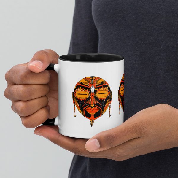 Orange and black African mask coffee mug with colorful rim, handle, and interior