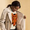 Orange and black African mask print crewneck sweatshirt with ribbed cuffs and hem
