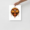 Black and orange African mask tribal art print displayed as matte wall art