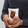 Black and orange anatomical heart coffee mug with colorful rim, handle, and interior