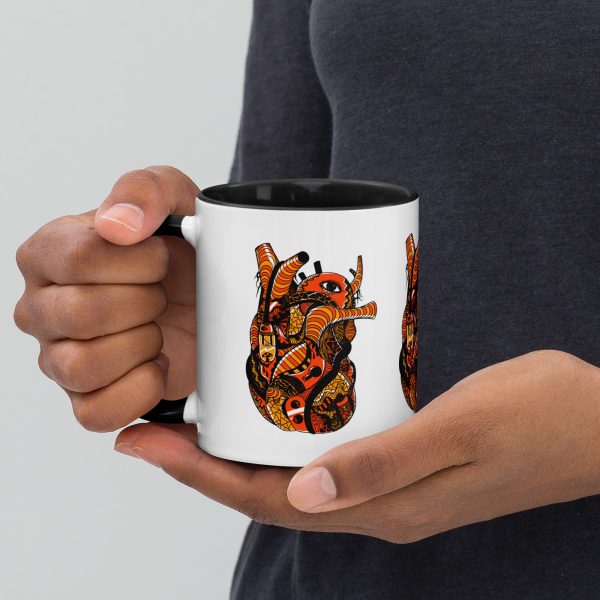 Black and orange anatomical heart coffee mug with colorful rim, handle, and interior