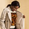 Orange and black abstract sweatshirt with ribbed crew neck and long sleeve cuffs for fall fashion