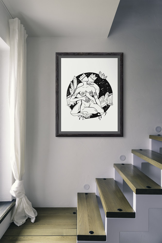 Romantic couple art featuring a black and white line drawing of an embracing couple surrounded by botanical elements and celestial details, displayed in a black frame on a gray wall
