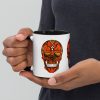 Day of the Dead sugar skull coffee mug in black and orange with colorful rim and handle