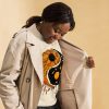 Orange and black yin yang sweatshirt with ribbed crew neck and long sleeve cuffs