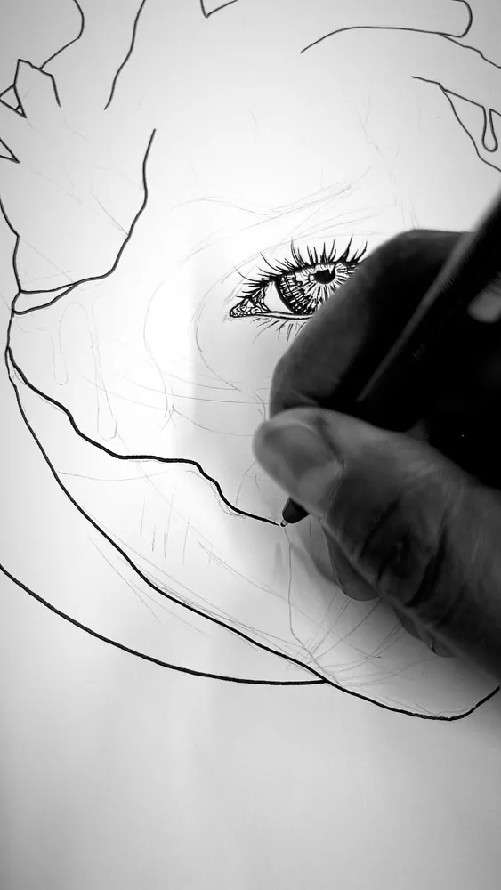 Close-up sketch detail of an ornate eye with patterned iris and surrounding botanical line work, part of an anatomical heart art composition.