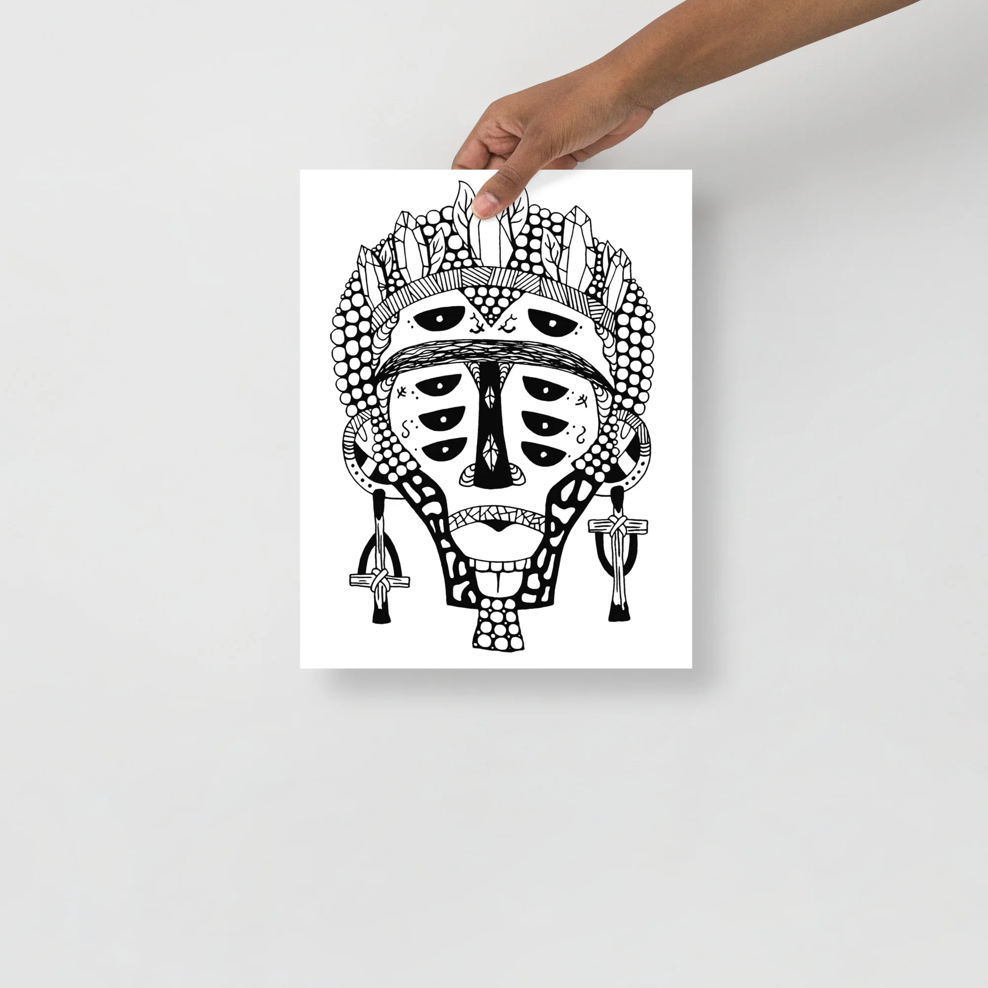 Bold black and white African mask drawing with geometric patterns, ornate headdress, and decorative ear pendants on matte art print