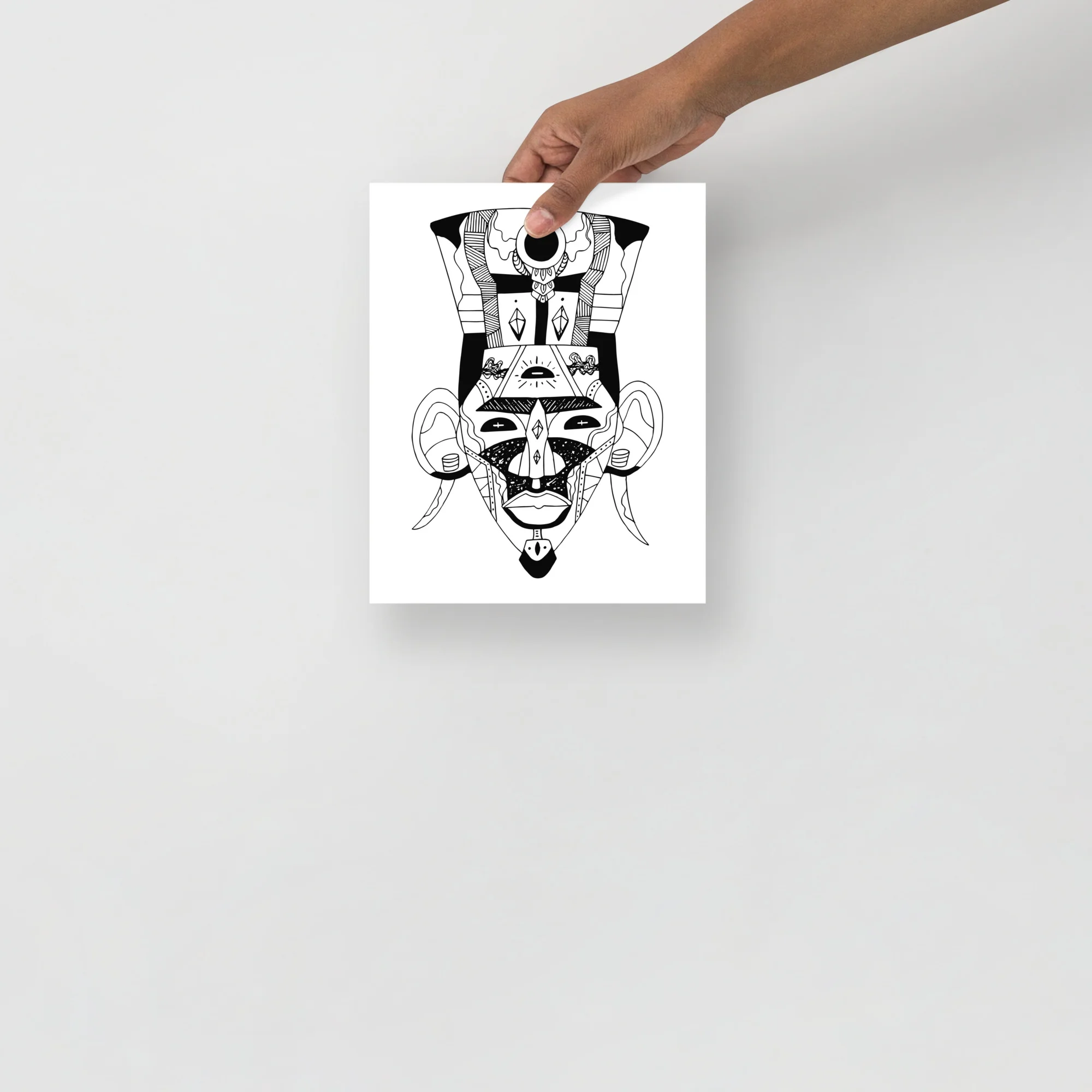 Black and white African mask art print featuring geometric tribal patterns and ceremonial design with bold linear details