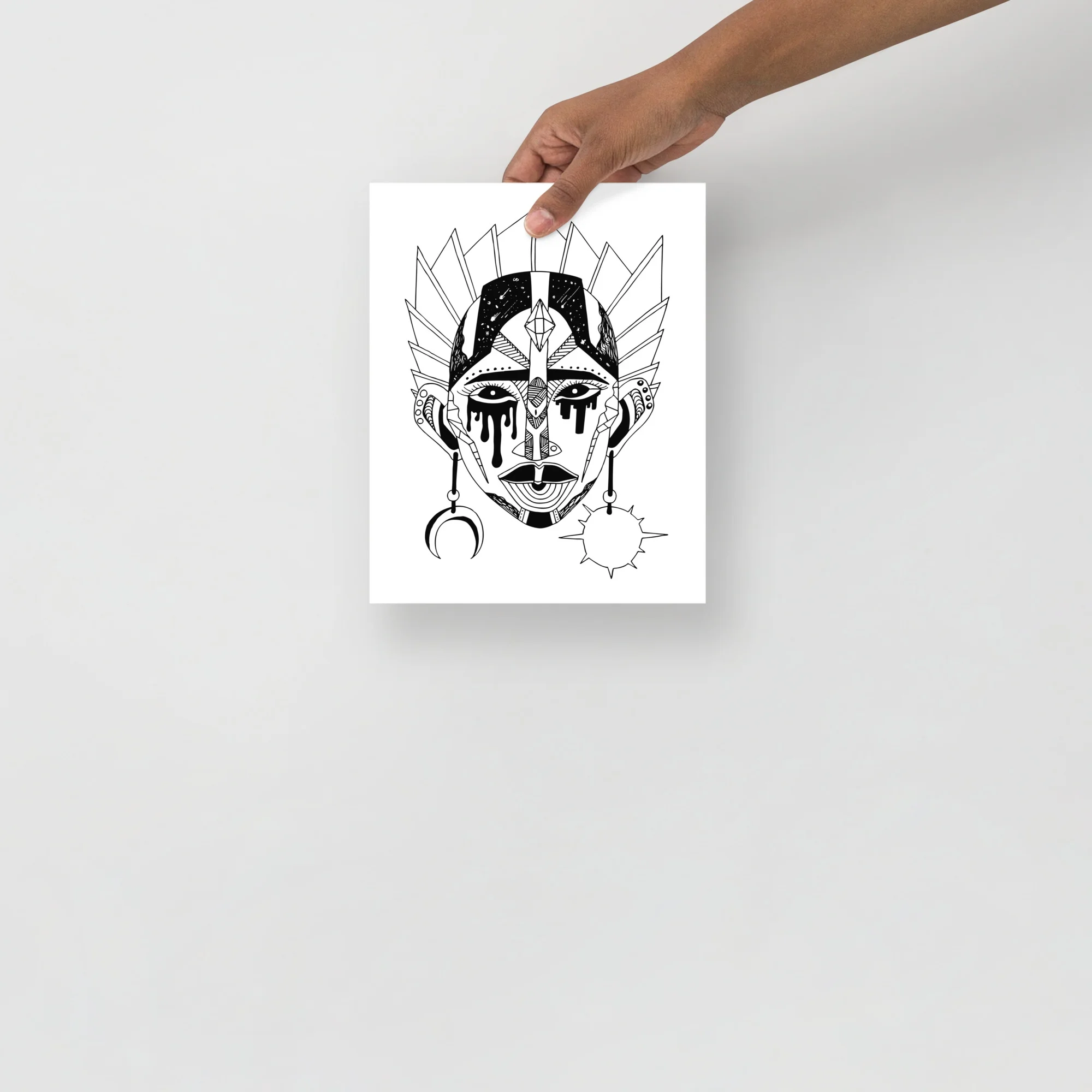 Striking black and white tribal mask art print featuring geometric patterns, mystical symbolism, and ornate facial design with moon and sun motifs.