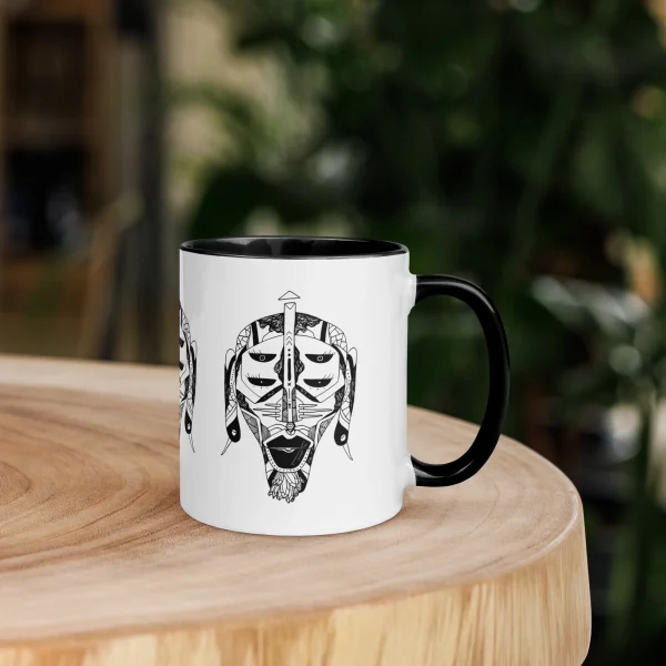 White African mask coffee mug with black handle and interior featuring bold tribal face art design
