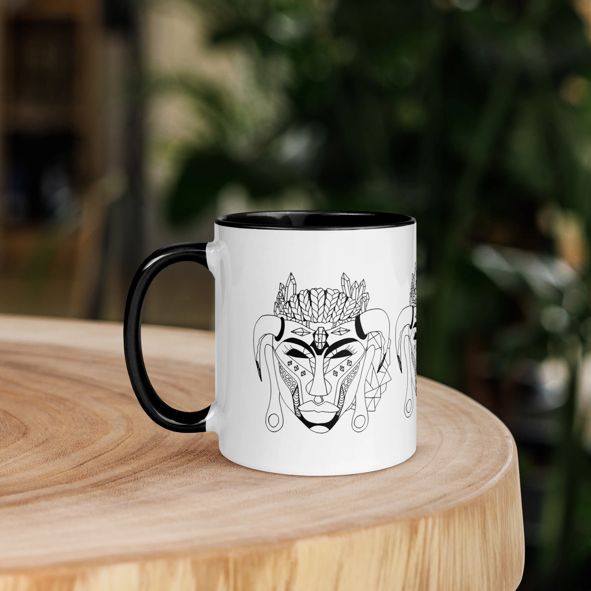 African mask coffee mug with bold line-art tribal face design featuring geometric patterns and leaf crown details on white ceramic