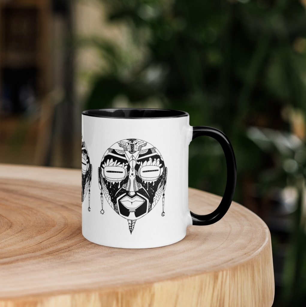 Striking afrocentric ceramic art mug with detailed african mask design and warm hues
