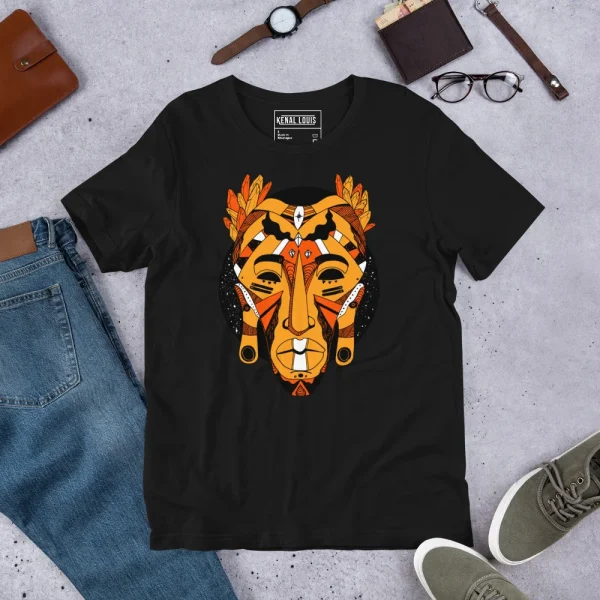 Black African mask t-shirt with bold orange and gold tribal face design, flat lay styling