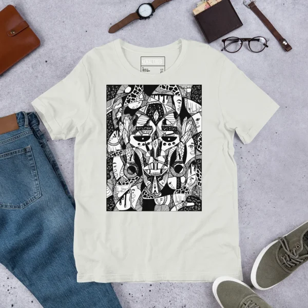Cream African mask t-shirt featuring intricate black and white Afrocentric artwork displayed flat lay with accessories