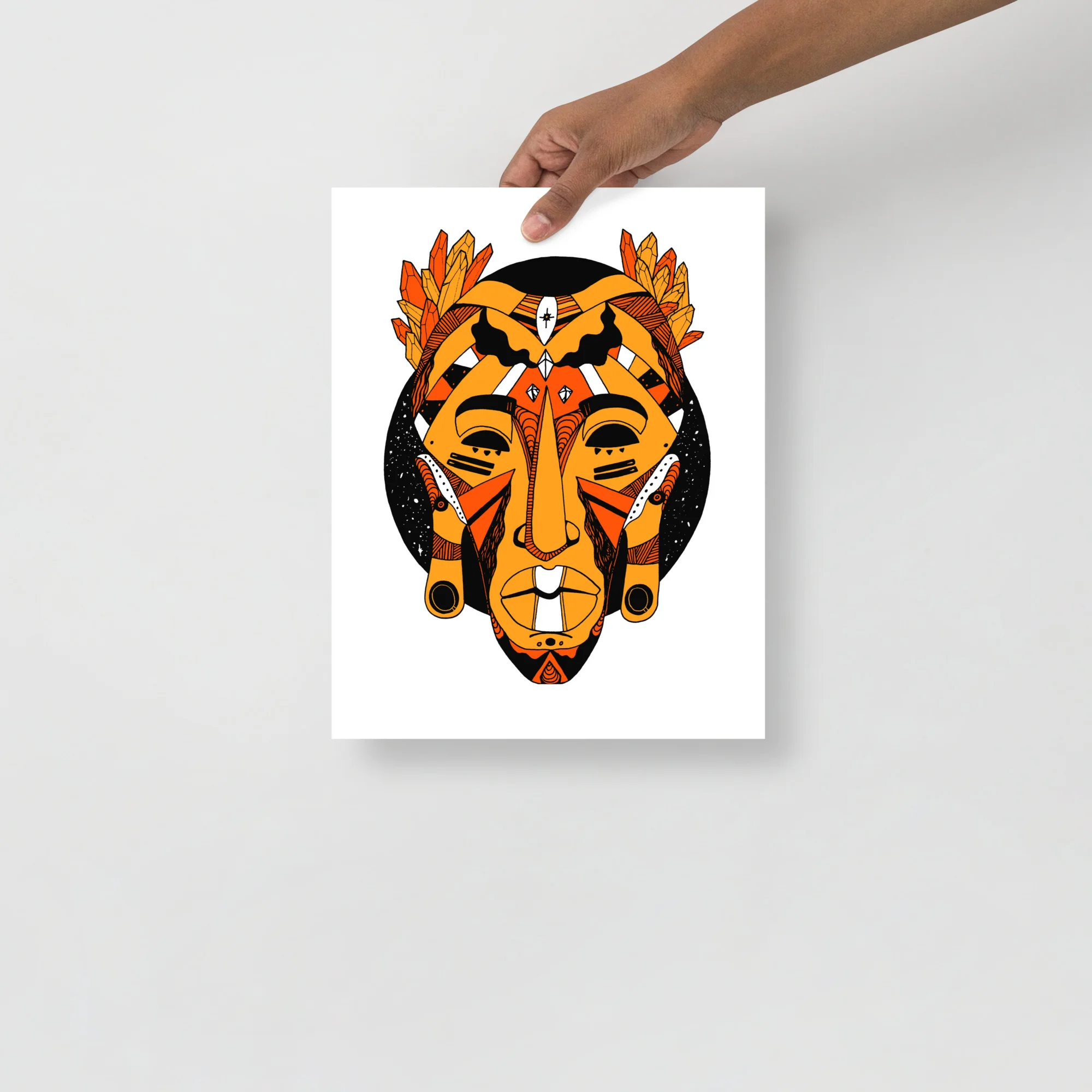 African mask wall art print featuring bold orange and black tribal design with feathered headdress