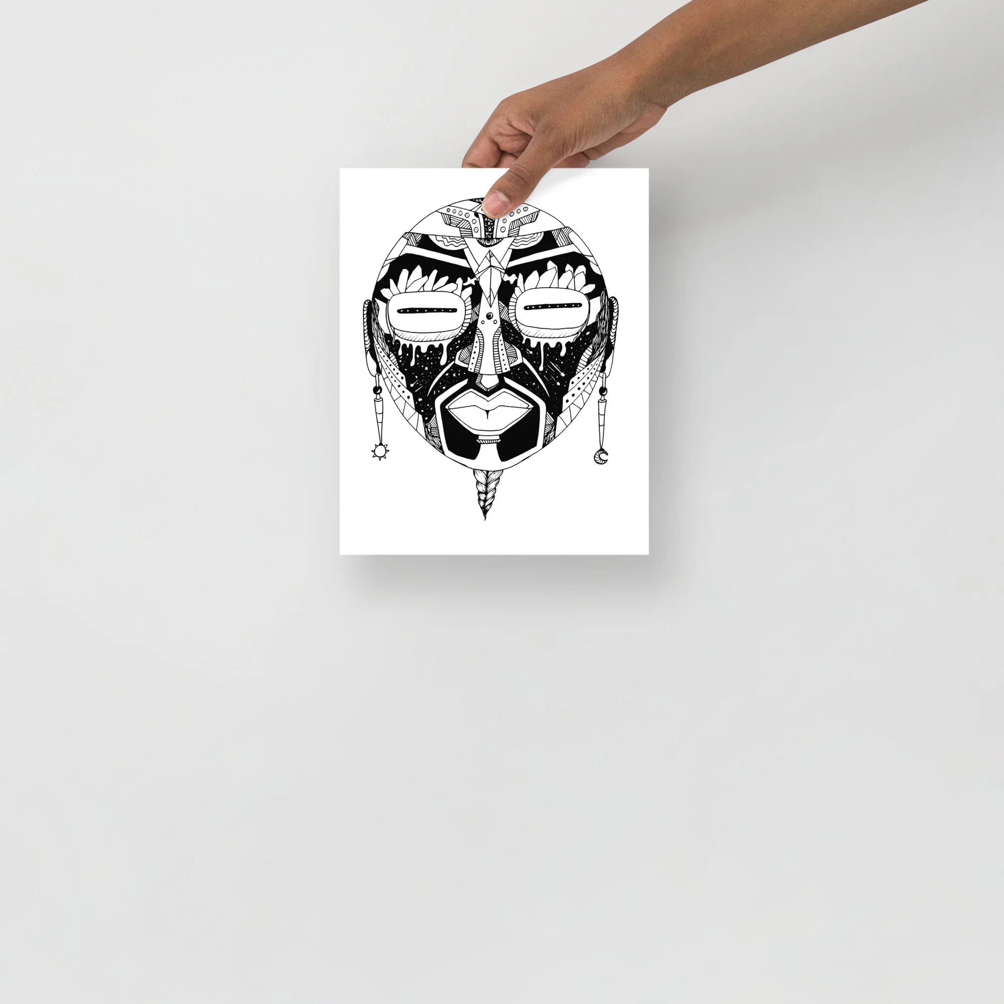 Black and white African mask wall art print featuring oval face with detailed tribal patterns, earrings and geometric designs