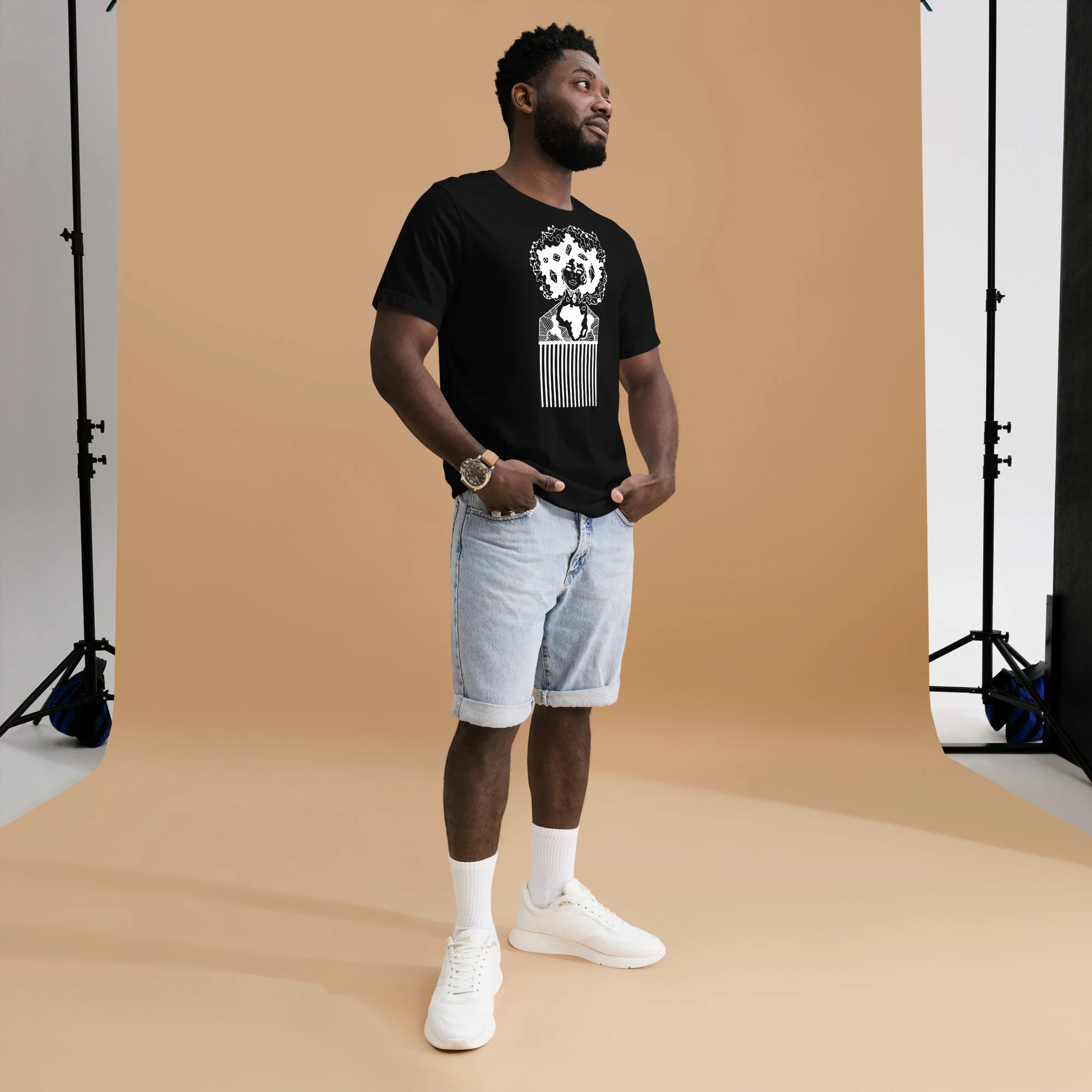 Man wearing black afro hair pick t-shirt with white line art design and light denim shorts