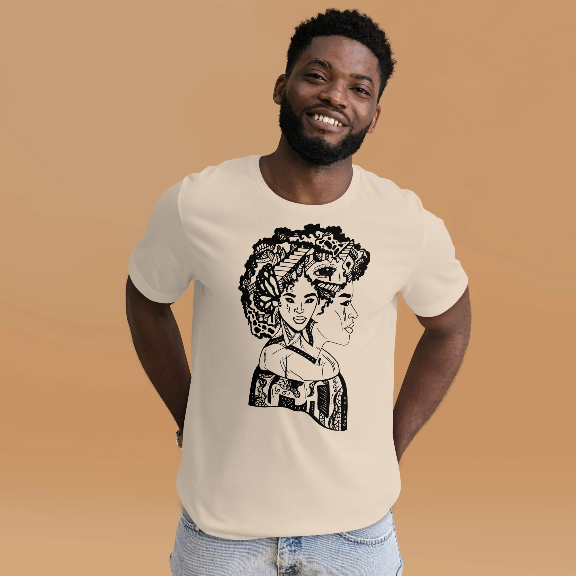 Afro woman t-shirt in cream with black graphic design featuring stylized portrait, worn by smiling model against tan background