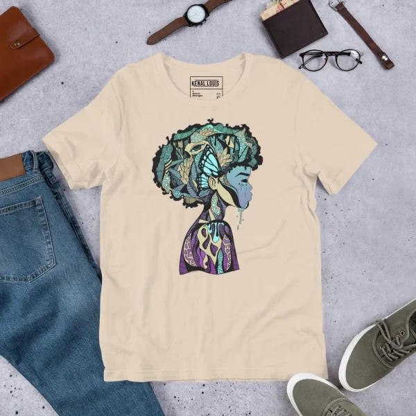 Cream afrocentric art t-shirt featuring a colorful profile silhouette with intricate patterns in teals, purples, and golds.