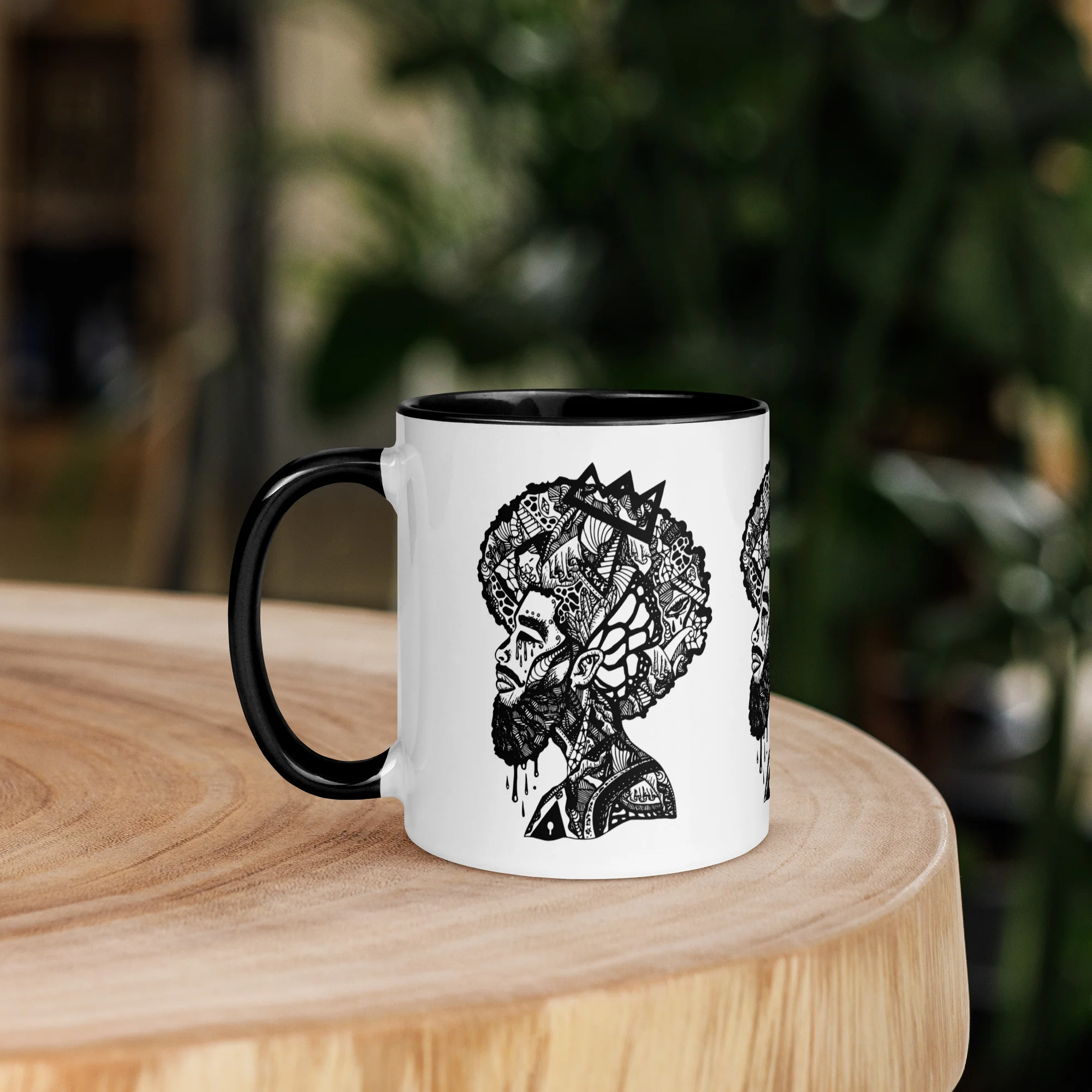 Afrocentric coffee mug with intricate black ink profile silhouette artwork featuring detailed patterns and Crown design on white ceramic with black handle.