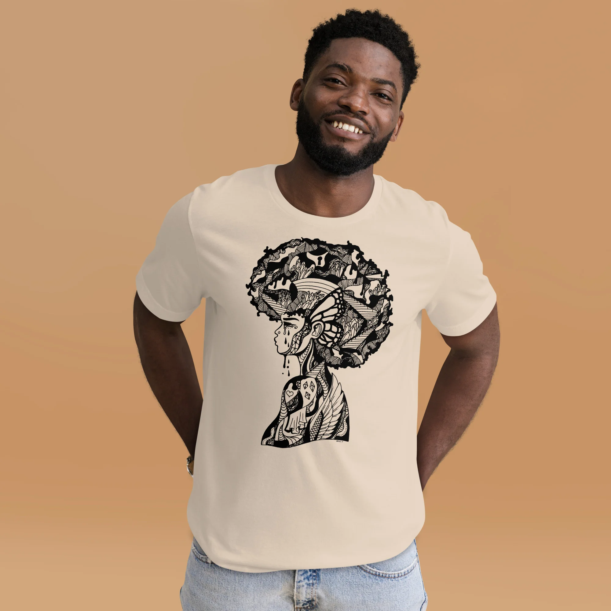 Man wearing cream afrocentric t-shirt with intricate black graphic depicting a woman's profile and natural afro filled with detailed patterns
