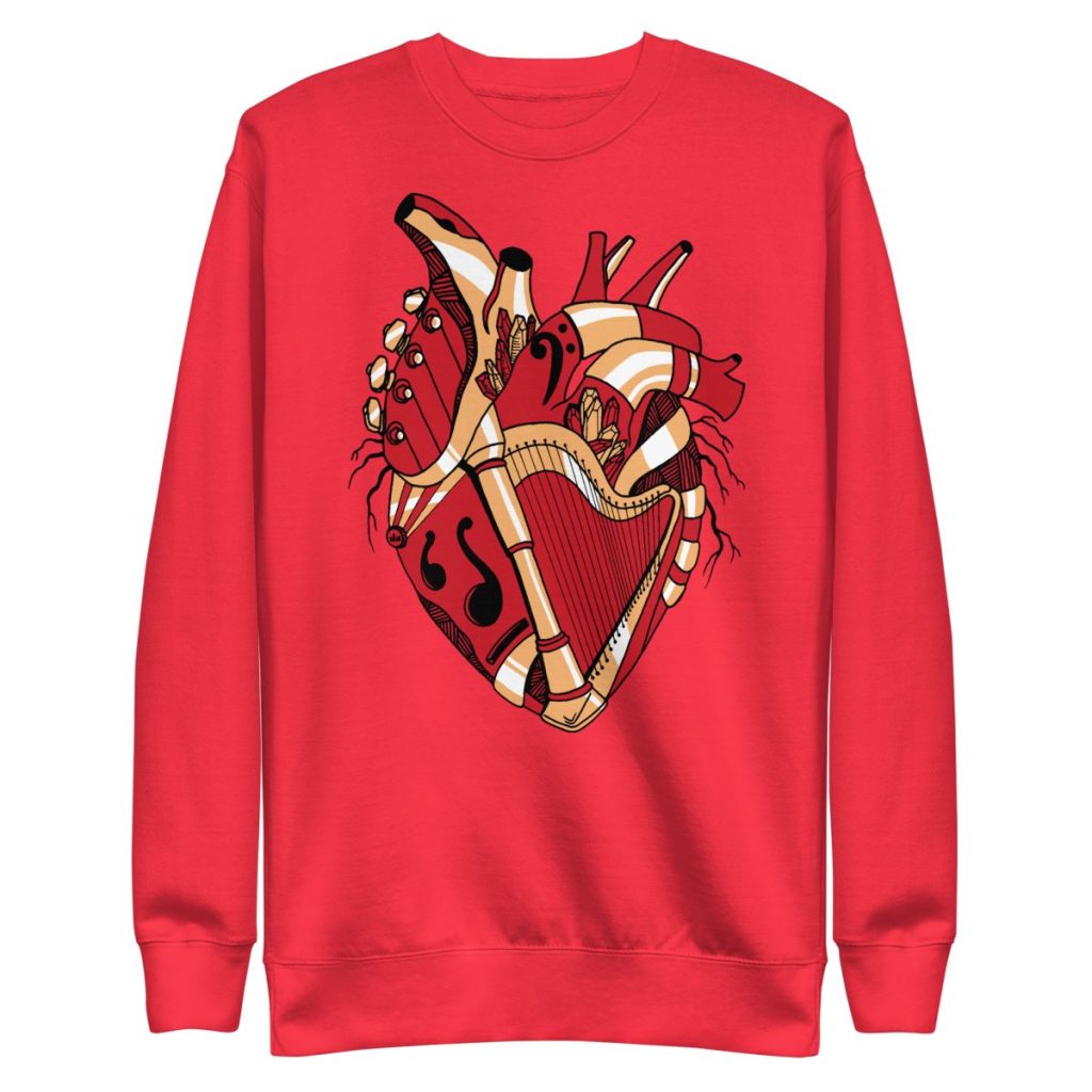 Red and cream musical anatomical heart sweatshirt featuring sheet music woven through heart