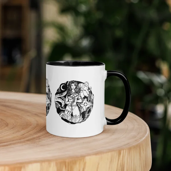 Aries zodiac mug for women featuring bold line art illustration with black interior and handle on wood table