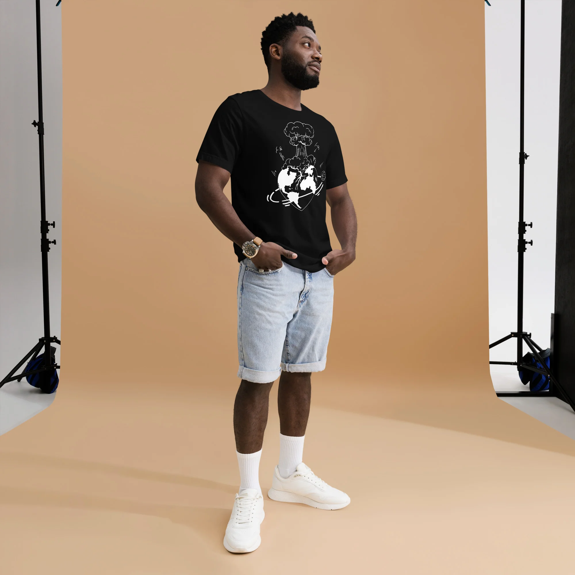 Man wearing black atomic heart t-shirt with white line art graphic design, paired with light denim shorts.