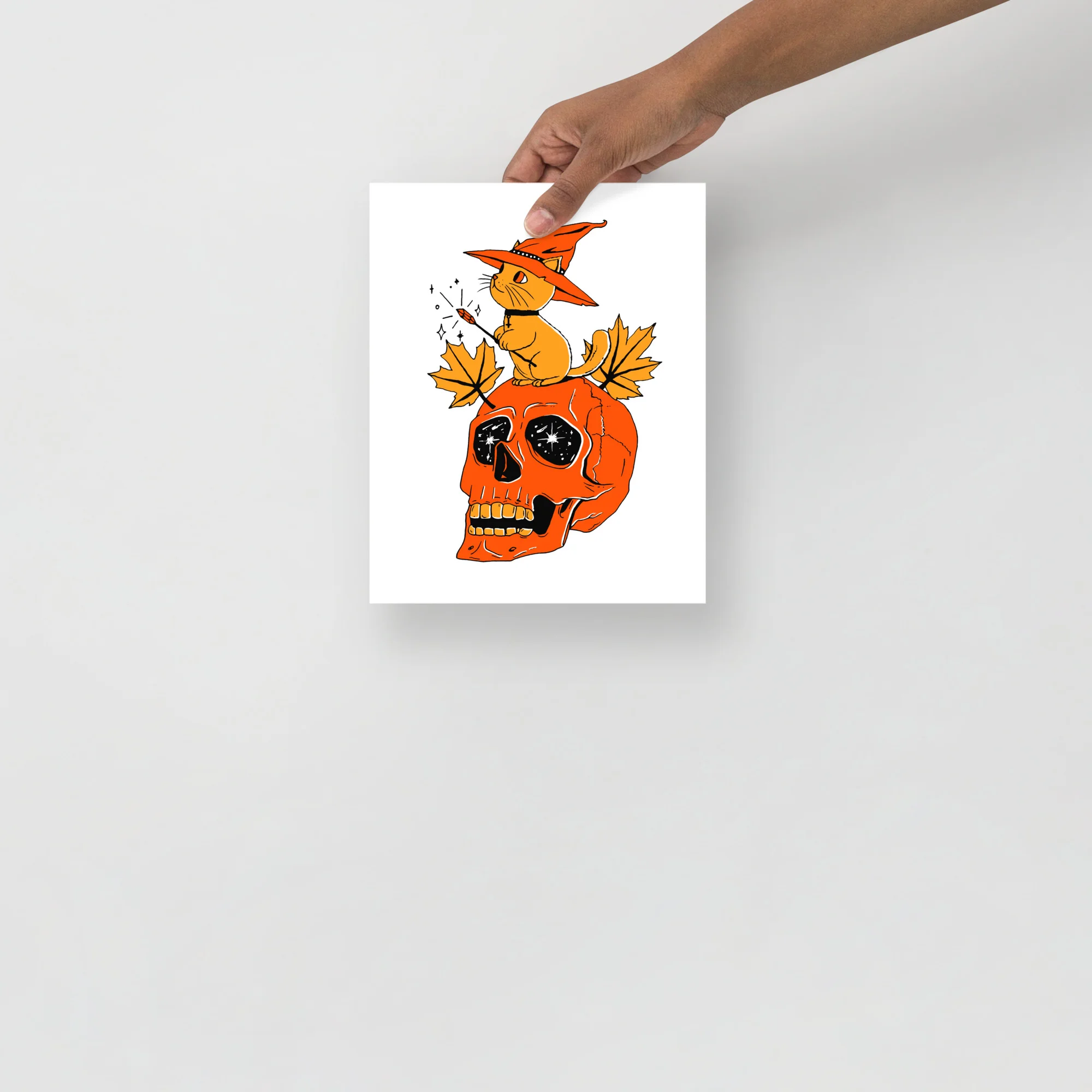 Black and orange cat art print featuring a witch cat on an orange skull with autumn leaves and mystical details