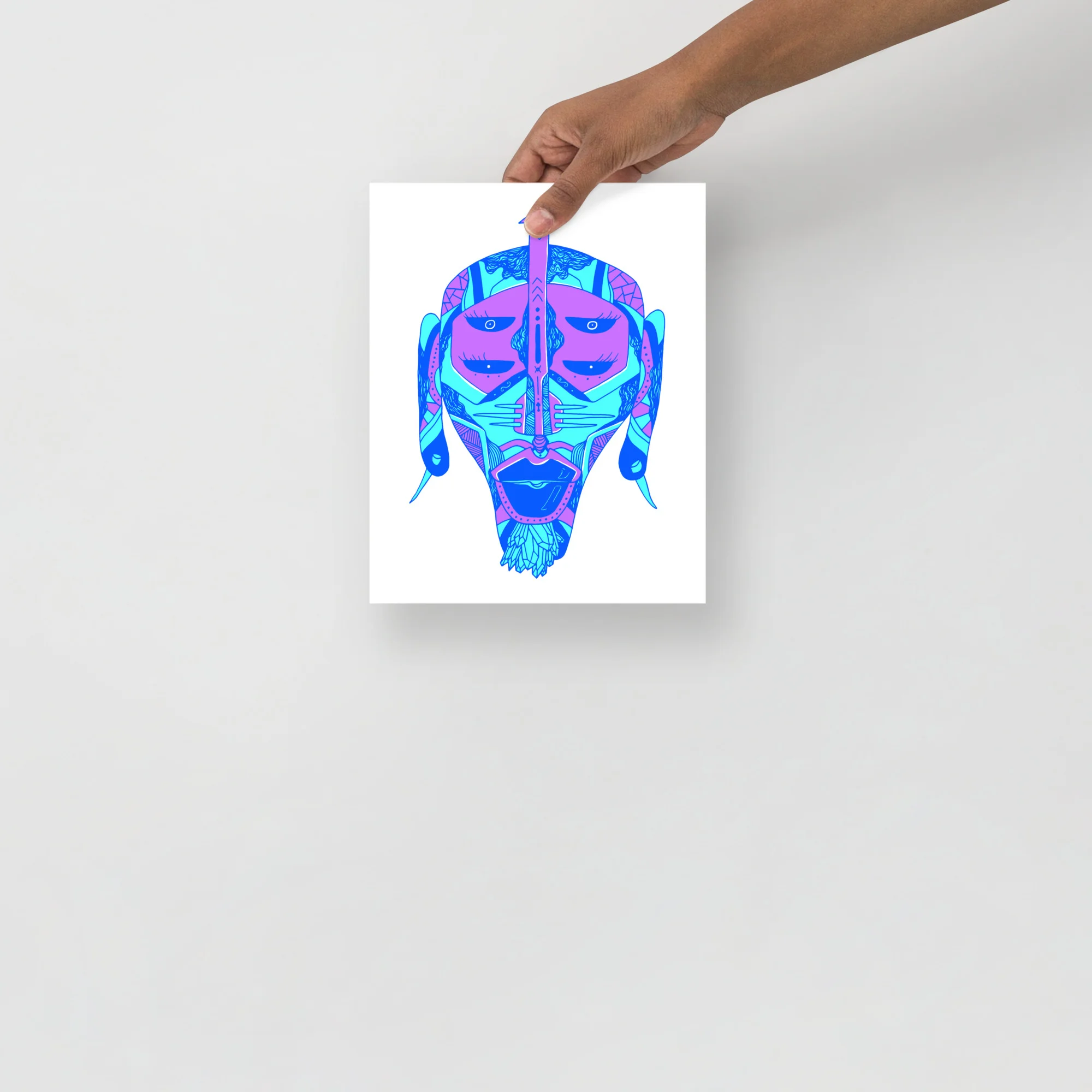 Bold blue African mask art print with magenta and cyan geometric patterns and sculptural features displayed on matte paper