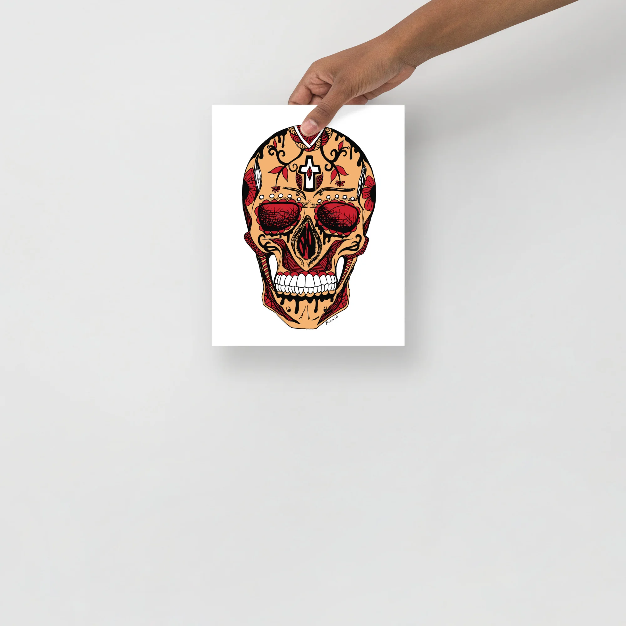Day of the Dead skull art print featuring intricate red and gold filigree patterns with a white cross motif on tan background
