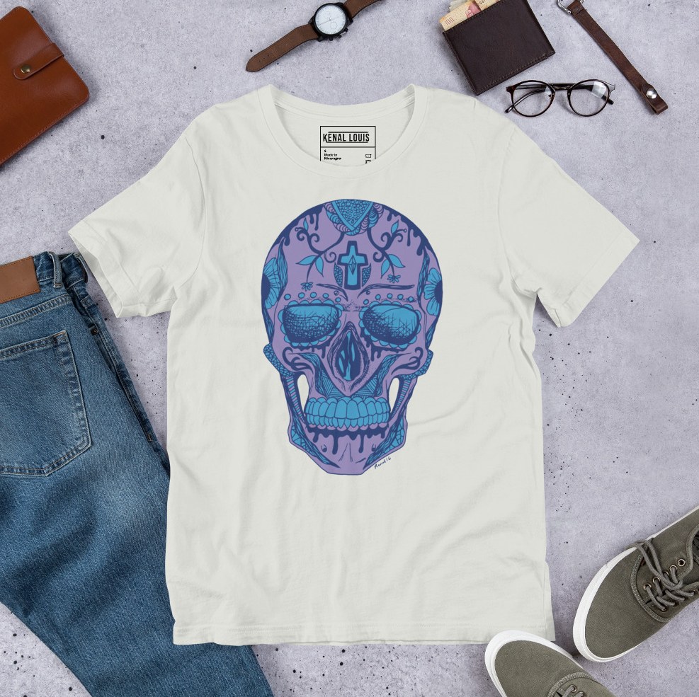Mountain blue tee featuring intricate skull design inspired by dia de los muertos