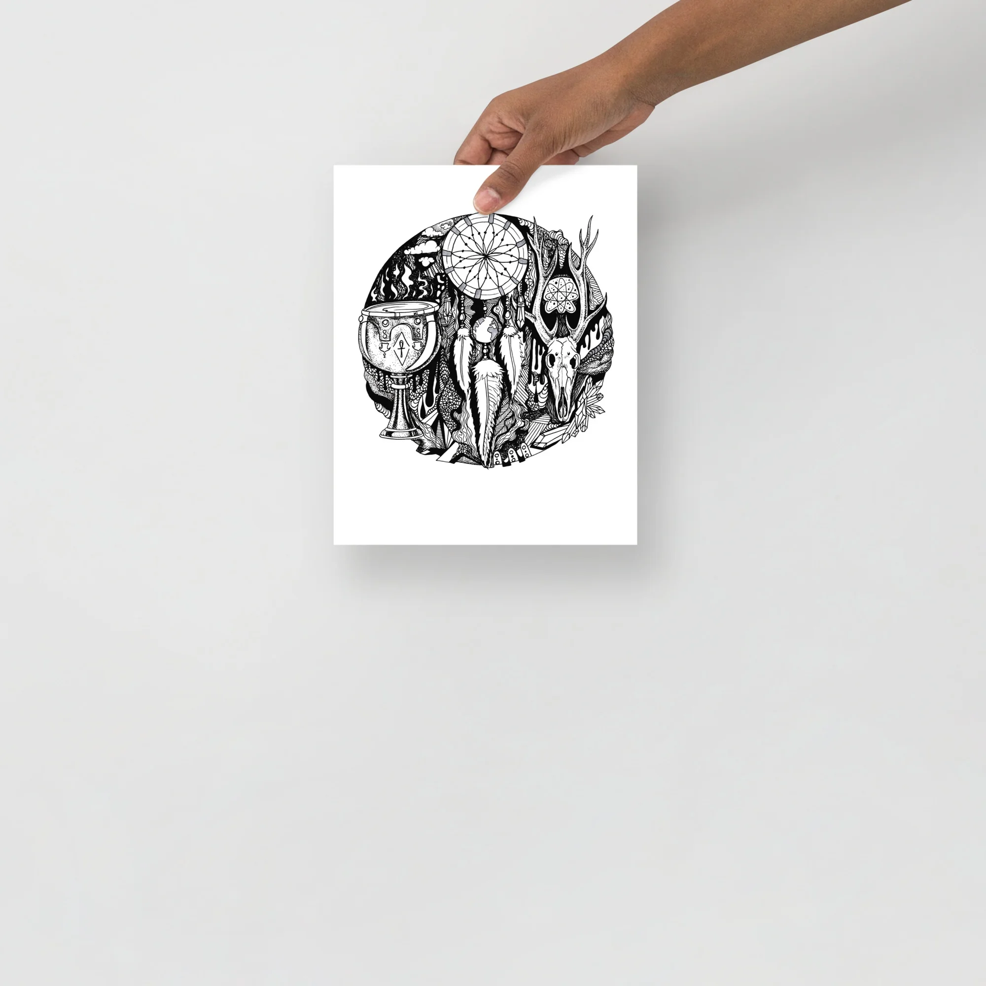 Hand holding dreamcatcher artwork print featuring intricate pen and ink desert-inspired design with symbolic elements