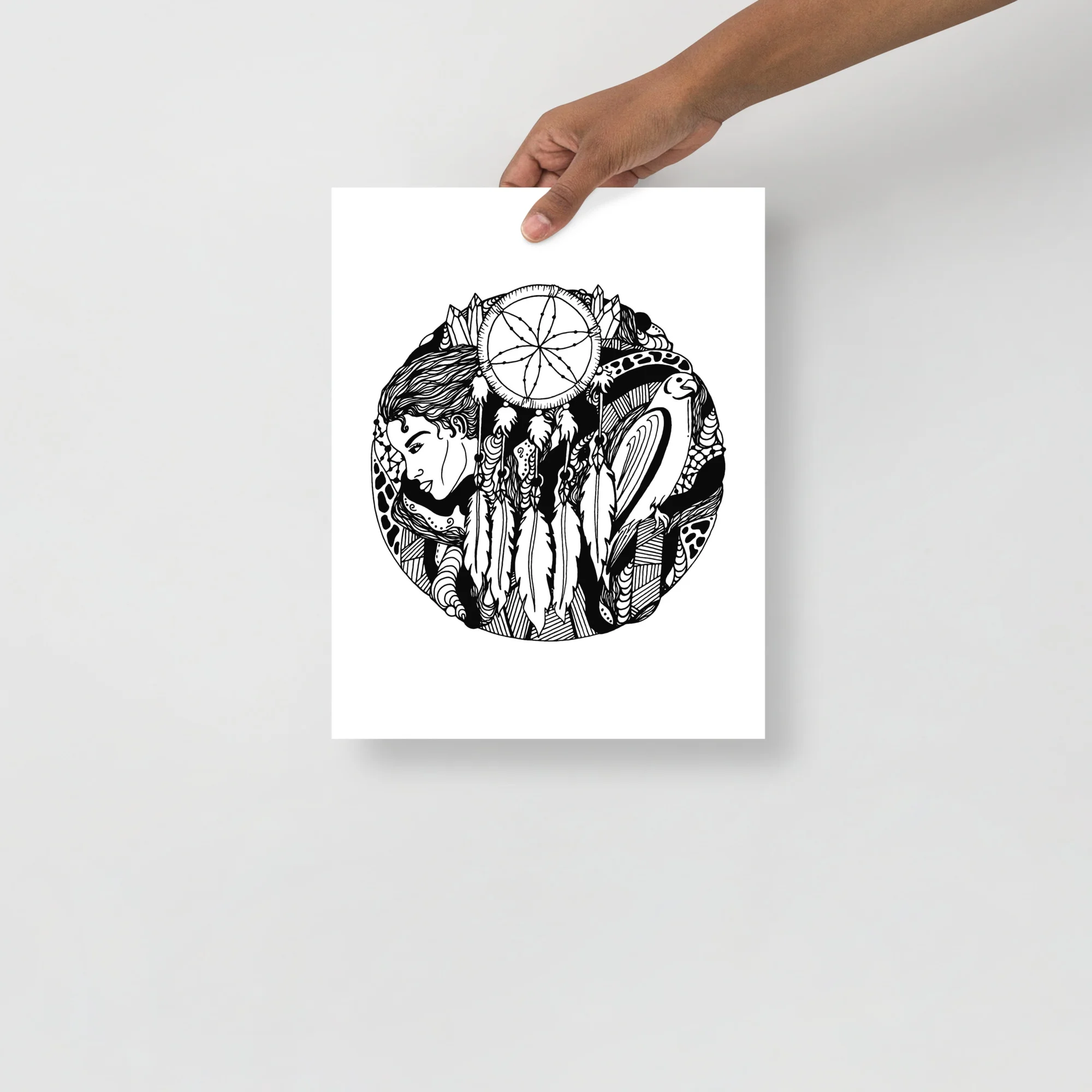 Hand-drawn dreamcatcher drawing featuring a falcon and feminine portrait with intricate tribal details in black ink on white paper.