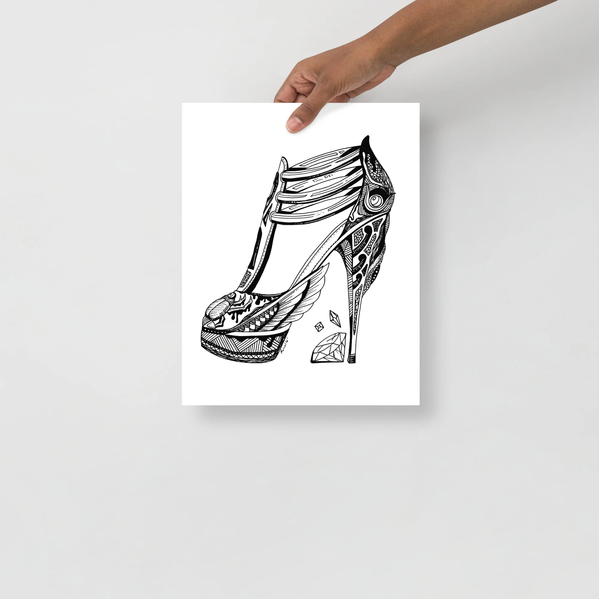 Black ink line drawing of an ornate high heel shoe with intricate patterned details and goddess isis symbolism