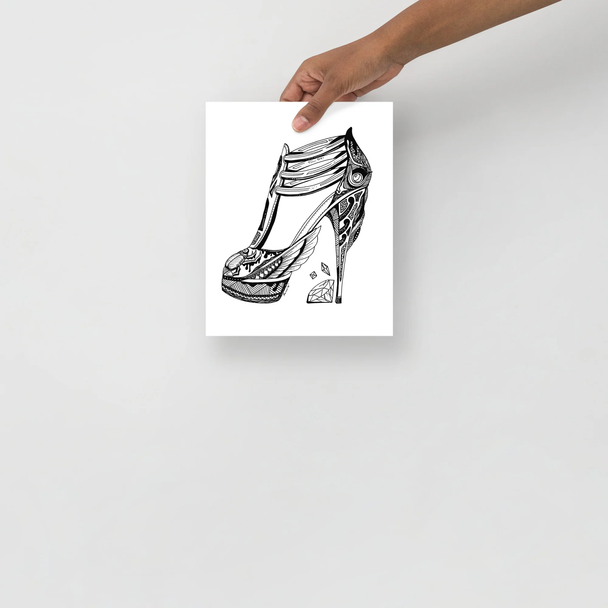Goddess Isis art print featuring an ornate high heel shoe with decorative patterns and a diamond accent in black ink on white paper