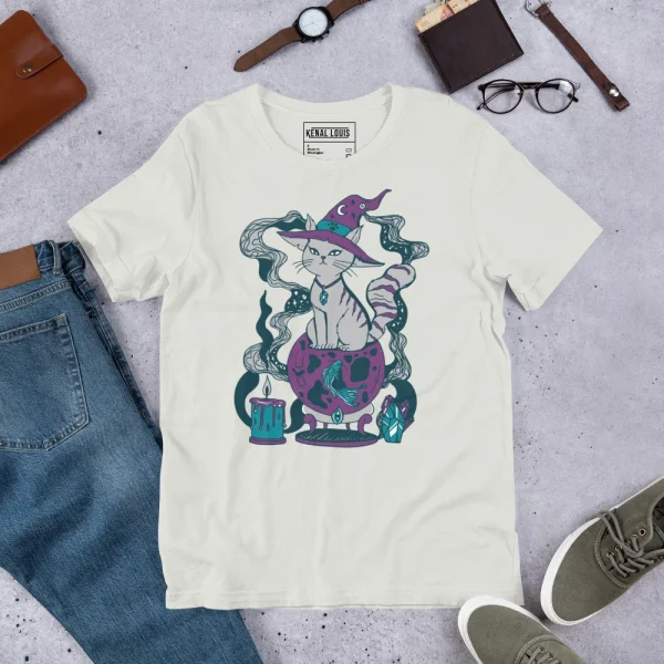 Cream-colored grey cat t-shirt featuring a magical cat design with witch hat, crystal ball, and mystical elements in purple and teal