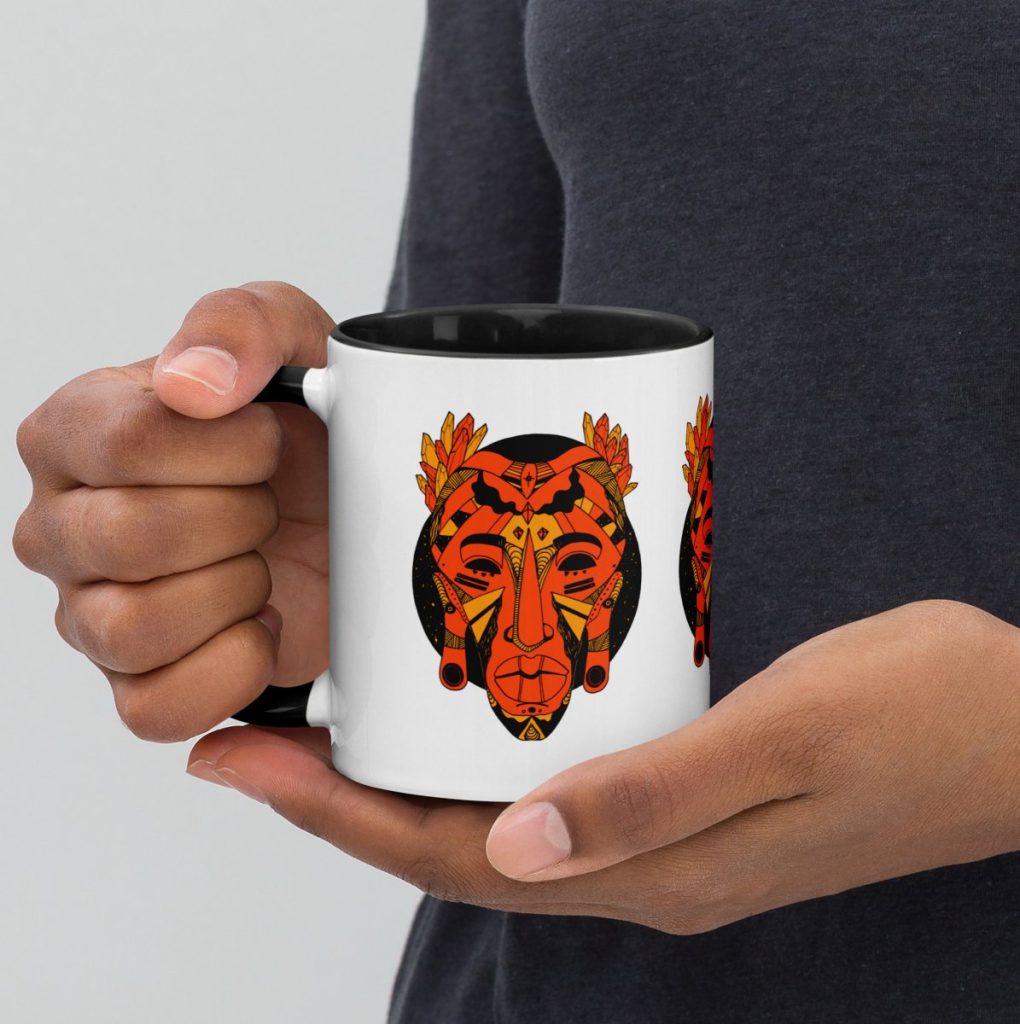 African mask artwork displayed on orange and black art drinkware for halloween
