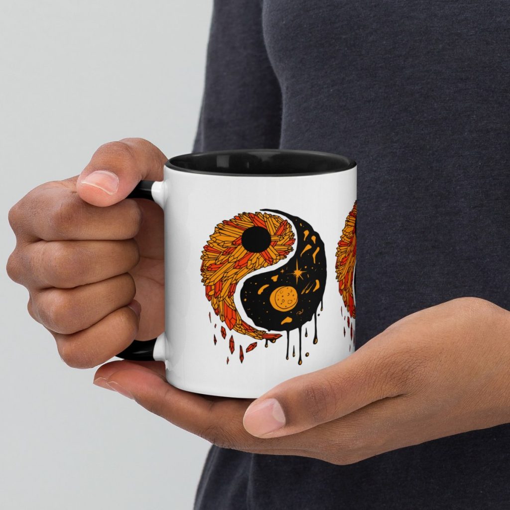 Yin yang balance depicted on this orange and black halloween coffee mug
