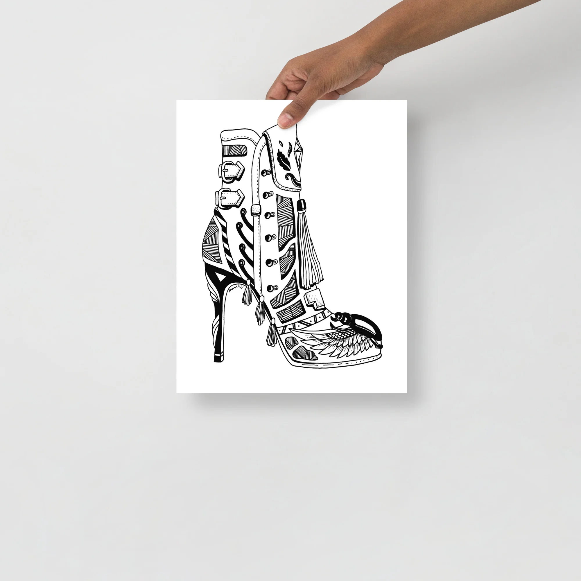 Black and white line art illustration of a high heel boots design with ornate details, feather motifs, and lace-up front.